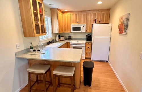 Medford House | Bring everyone together while enjoying the privacy of three separate living spaces. This unique Medford retreat features a spacious main home, two private guest homes, a seasonal pool, hot tub, fully equipped kitchens, and room for the whole family.