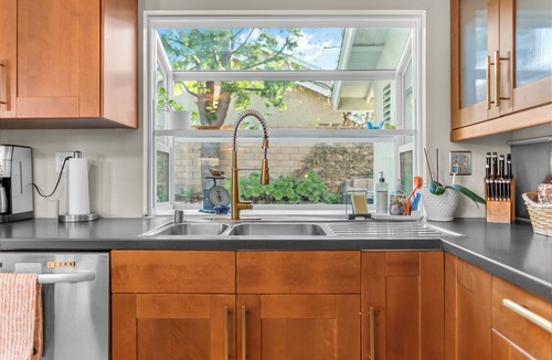 Corona House | Enjoy a comfortable 3-bedroom home in Corona featuring a private pool with a waterslide, outdoor kitchen, fire pit, and dedicated workspaces. Designed for 30+ day stays, this home is ideal for relocation guests, insurance housing, corporate travelers