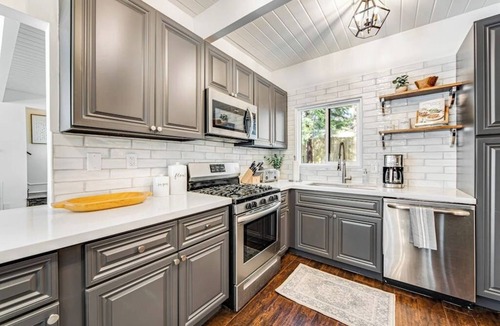 Cedar Glen House | Stunning lakehouse lodge with a deck, fireplace, lush patio & lake access