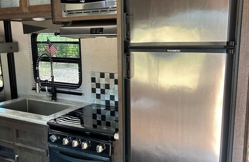 Mira Monte House | Winnebago camper set up on beautiful property with resort style pool and jacuzzi