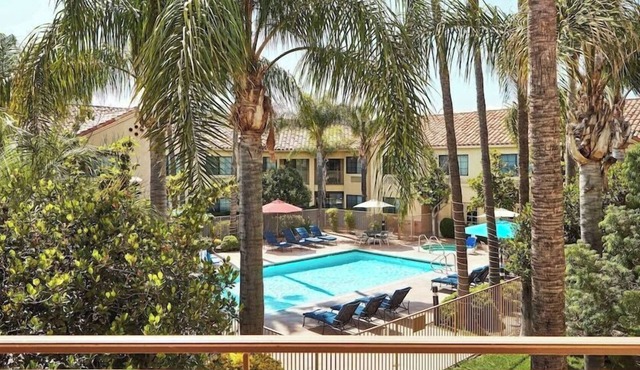 Grand Balcony King Room | Overlooking Pool & Courtyard | On-Site Dining