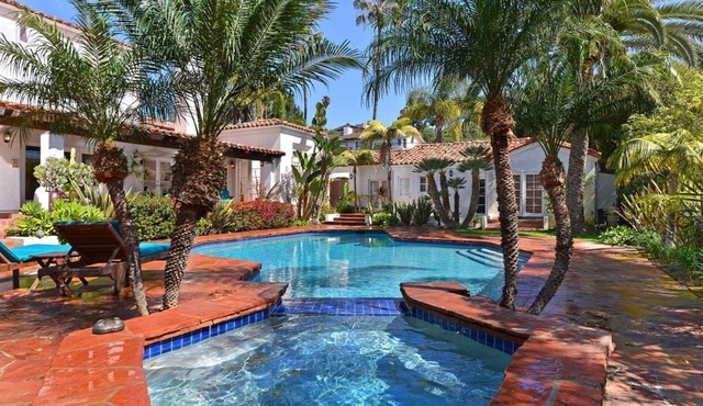 Mediterranean magic in a sun-kissed tropical oasis with pool and pizza oven.