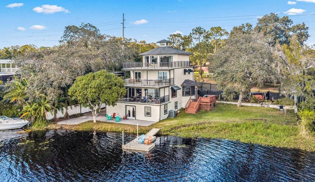 Sprawling river view estate with game room dock kayaks grill and fishing gear in Tampa